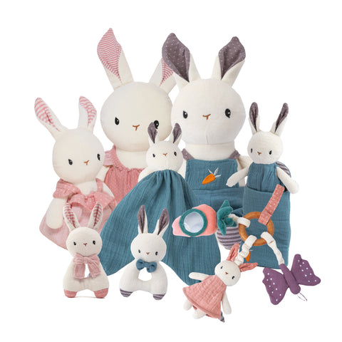 A collection of plush toy rabbits in pink and blue, with various accessories such as a bunny-shaped comforter and a activity ring.