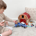 Child playing with Jumini wooden farm toys - jeep and horse trailer set
